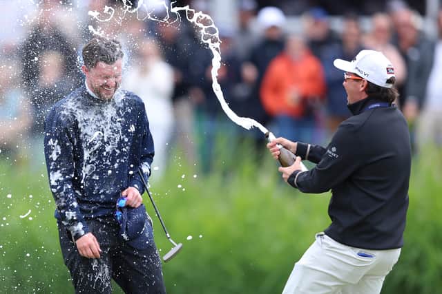 Connor Syme is spayed with champagne by fellow Scot and Modest! Golf stablemate Ewen Ferguson at the end of the KLM Open
