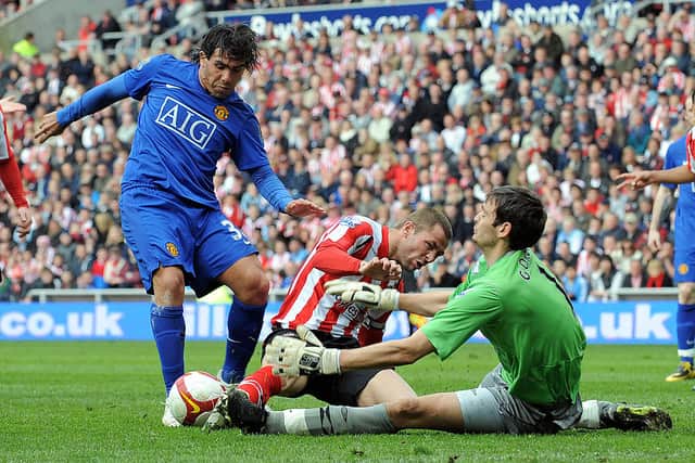 Craig Gordon thwarts then-Manchester United striker Carlos Tevez during his time at Sunderland.