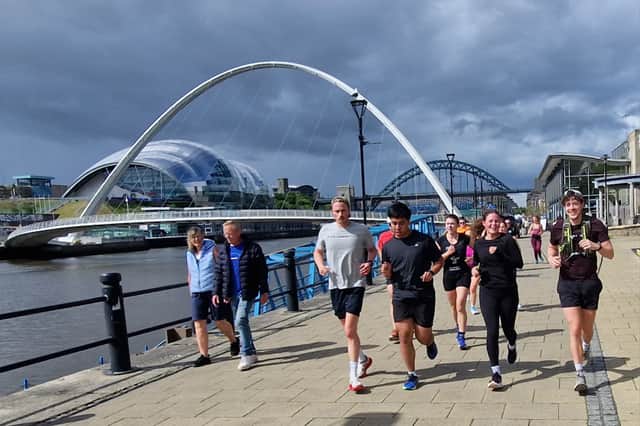 The INNSiDE Road Runners pass the Gateshead Millennium Bridge on June 1