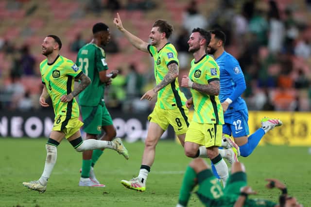 Hibs winger Martin Boyle (left) celebrates Australia's win over Saudi Arabia and subsequent qualification for the 2026 World Cup with teammates Connor Metcalfe and Aiden O'Neill at King Abdullah Sports City in Jeddah. (Photo by Yasser Bakhsh/Getty Images)