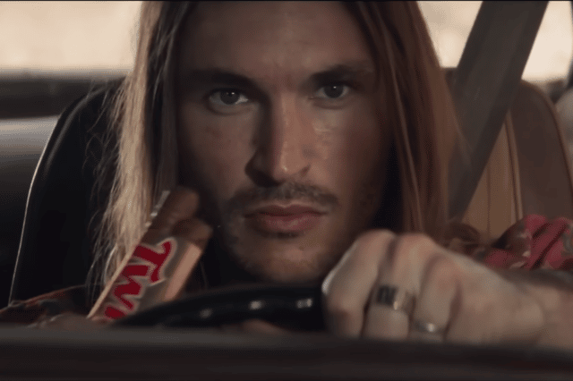 A television advert for Twix biscuits has been banned by the ASA for promoting "dangerous" and "irresponsible" driving