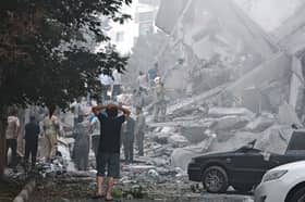 People look over damage to buildings in Nobonyad Square following Israeli airstrikes in Tehran, Iran. Iran's three top military generals were killed in the attacks that also targeted nuclear and military facilities