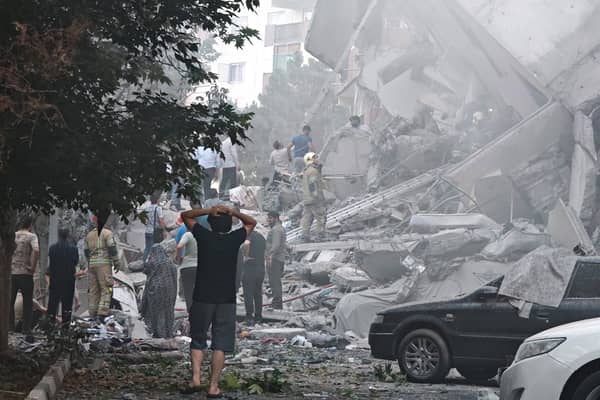People look over damage to buildings in Nobonyad Square following Israeli airstrikes in Tehran, Iran. Iran's three top military generals were killed in the attacks that also targeted nuclear and military facilities