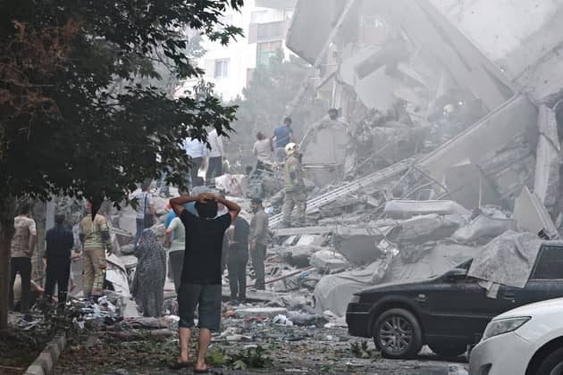 People look over damage to buildings in Nobonyad Square following Israeli airstrikes in Tehran, Iran. Iran's three top military generals were killed in the attacks that also targeted nuclear and military facilities