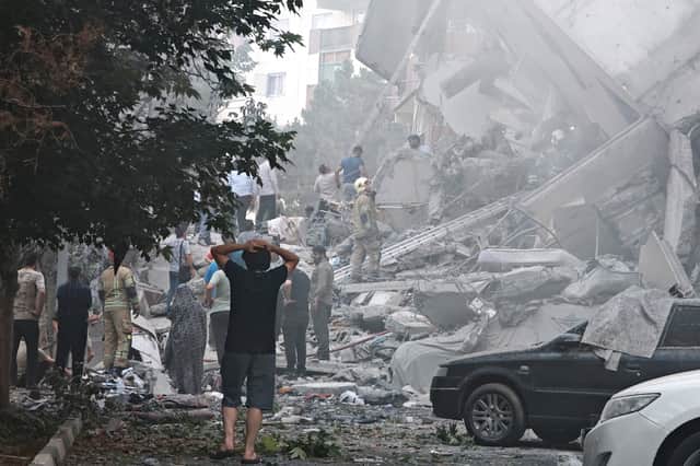 People look over damage to buildings in Nobonyad Square following Israeli airstrikes in Tehran, Iran. Iran's three top military generals were killed in the attacks that also targeted nuclear and military facilities