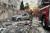 First-responders gather outside a building that was hit by an Israeli strike in Tehran on Friday