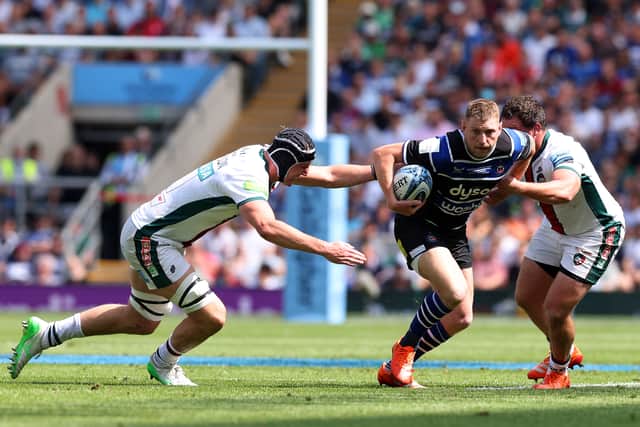 Bath's Finn Russell tries to squeeze between Leicester's Cameron Henderson, left, and Julian Montoya.