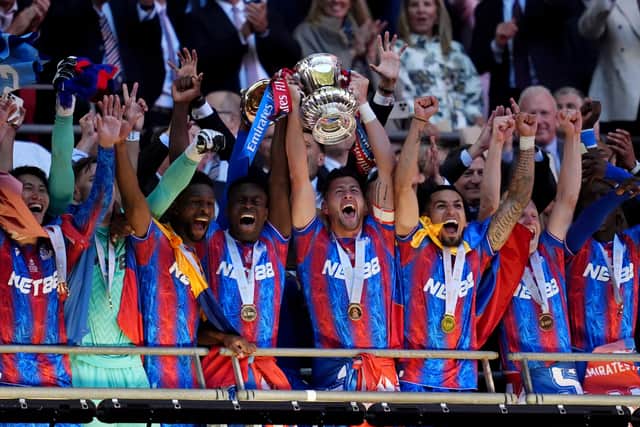 Crystal Palace's Marc Guehi (centre left) and Joel Ward (centre right) lift the FA Cup after the Emirates FA Cup final at Wembley Stadium, London. Picture date: Saturday May 17, 2025.