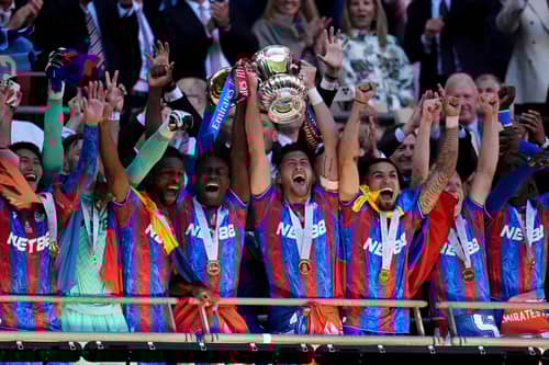 Crystal Palace's Marc Guehi (centre left) and Joel Ward (centre right) lift the FA Cup after the Emirates FA Cup final at Wembley Stadium, London. Picture date: Saturday May 17, 2025.