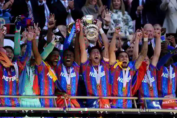 Crystal Palace's Marc Guehi (centre left) and Joel Ward (centre right) lift the FA Cup after the Emirates FA Cup final at Wembley Stadium, London. Picture date: Saturday May 17, 2025.