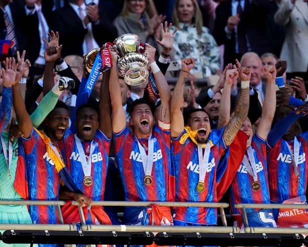 Crystal Palace's Marc Guehi (centre left) and Joel Ward (centre right) lift the FA Cup after the Emirates FA Cup final at Wembley Stadium, London. Picture date: Saturday May 17, 2025.