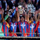 Crystal Palace's Marc Guehi (centre left) and Joel Ward (centre right) lift the FA Cup after the Emirates FA Cup final at Wembley Stadium, London. Picture date: Saturday May 17, 2025.