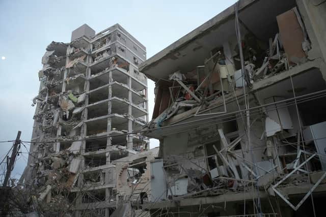 Israeli security forces inspect destroyed buildings that were hit by a missile fired from Iran, near Tel Aviv. Picture: AP Photo/Ohad Zwigenberg