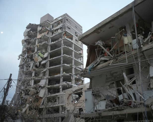 Israeli security forces inspect destroyed buildings that were hit by a missile fired from Iran, near Tel Aviv. Picture: AP Photo/Ohad Zwigenberg