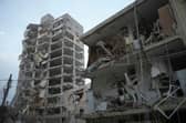 Israeli security forces inspect destroyed buildings that were hit by a missile fired from Iran, near Tel Aviv. Picture: AP Photo/Ohad Zwigenberg