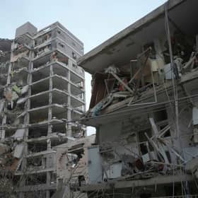 Israeli security forces inspect destroyed buildings that were hit by a missile fired from Iran, near Tel Aviv. Picture: AP Photo/Ohad Zwigenberg