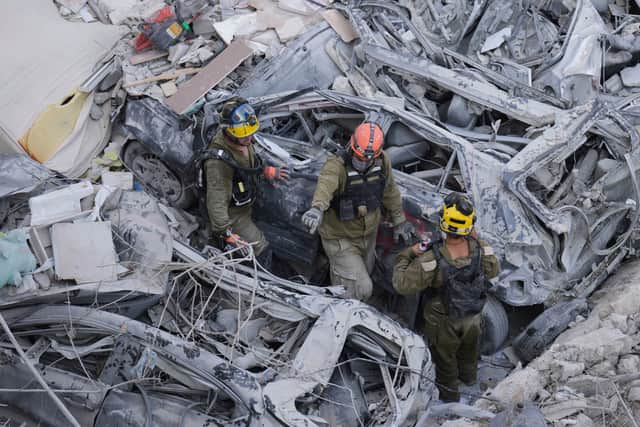 Israeli soldiers dig through rubble to search for survivors in a residential area hit by a missile fired from Iran, near Tel Aviv, on Sunday. Picture: AP Photo/Ariel Schalit