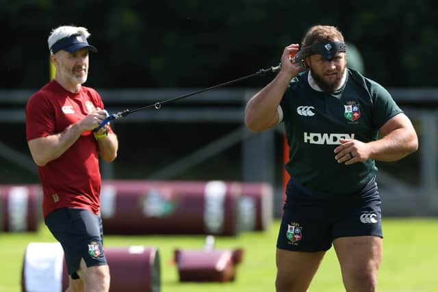 Pierre Schoeman stretches with Aled Walters, head of performance, during a British & Irish Lions training session at UCD Bowl in Dublin.
