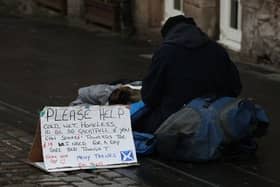 A homeless person and their dog on the Royal Mile in Edinburgh