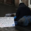 A homeless person and their dog on the Royal Mile in Edinburgh
