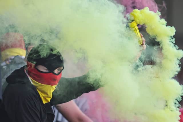 A Partick Thistle fan with a yellow flare during the Premiership Play-Off quarter-final second leg match against Ayr United at Somerset Park, on May 09, 2025. (Photo by Ross MacDonald / SNS Group)