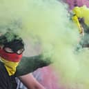 A Partick Thistle fan with a yellow flare during the Premiership Play-Off quarter-final second leg match against Ayr United at Somerset Park, on May 09, 2025. (Photo by Ross MacDonald / SNS Group)