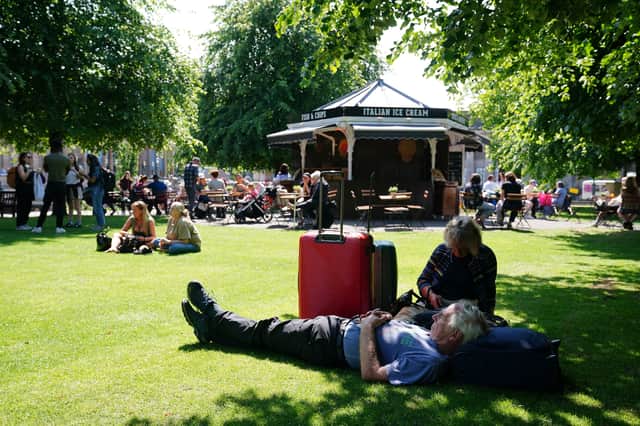People enjoying the warm weather in Edinburgh's Princes Street Gardens