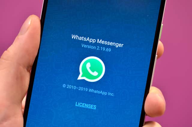 The WhatsApp app icon on a smartphone