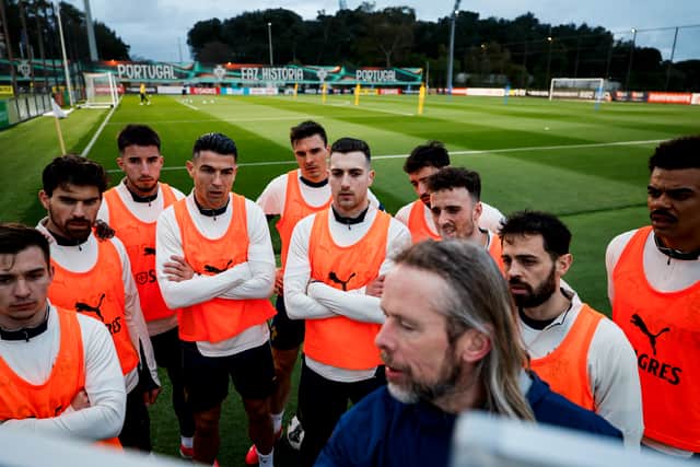 Cristiano Ronaldo and his Portugal teammates give their attention to assistant coach Austin MacPhee at the tactics board. Pic: Portuguese Football Federation