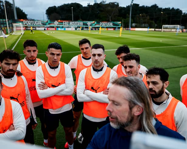 Cristiano Ronaldo and his Portugal teammates give their attention to assistant coach Austin MacPhee at the tactics board. Pic: Portuguese Football Federation