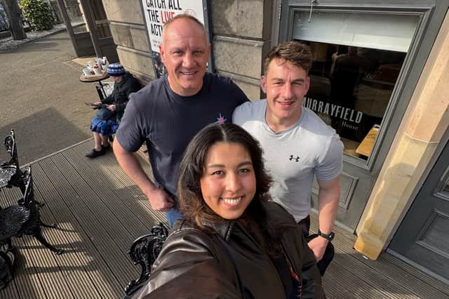 Lisa Simonis with Scotland and Lions assistant coach John Dalziel and Craig Jackson, head coach of Stirling County RFC, outside a coffee shop near Murrayfield, Edinburgh.