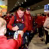 British and Irish Lions fly-half Finn Russell signs autographs for a fan upon arrival at Perth International Airport on June 22, 2025, ahead of the team's rugby match against Western Force.