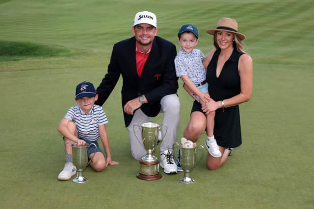 US Ryder Cup captain Keegan Bradley shows off the trophy along with his wife Jillian and sons Logan and Cooper after winning the Travelers Championship at TPC River Highlands in Cromwell, Connecticut