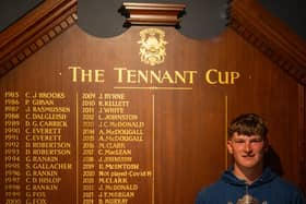Will Coxon, a student at the University of Stirling, shows off the Tennant Cup at Glasgow Golf Club