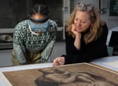 Curators examine drawings in the exhibition to be held at the Palace of Holyroodhouse.