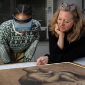 Curators examine drawings in the exhibition to be held at the Palace of Holyroodhouse.