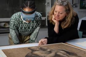 Curators examine drawings in the exhibition to be held at the Palace of Holyroodhouse.