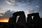 The sun rises over Stonehenge on the summer solstice, an event that attracted record crowds of druids, sun devotees, tourists and others (Picture: Finnbarr Webster)