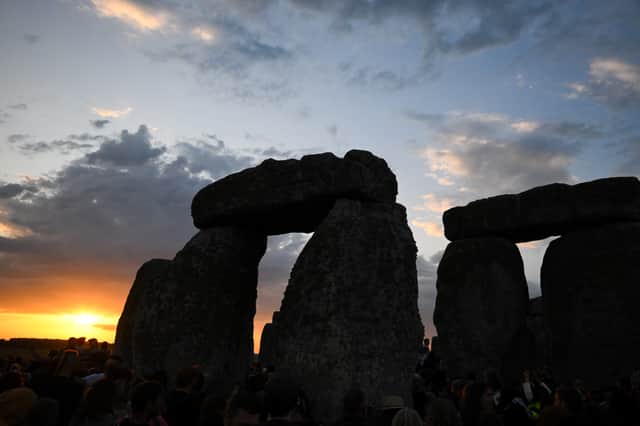 The sun rises over Stonehenge on the summer solstice, an event that attracted record crowds of druids, sun devotees, tourists and others (Picture: Finnbarr Webster)
