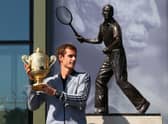 Andy Murray's poses with his first Wimbledon singles trophy in front of the statue of Fred Perry (Picture: Julian Finney)