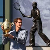 Andy Murray's poses with his first Wimbledon singles trophy in front of the statue of Fred Perry (Picture: Julian Finney)