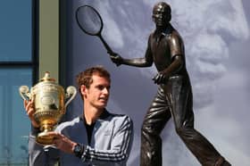 Andy Murray's poses with his first Wimbledon singles trophy in front of the statue of Fred Perry (Picture: Julian Finney)