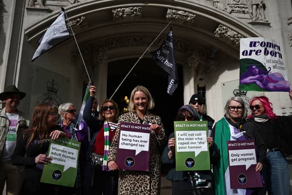 Campaigners celebrate the recent Supreme Court ruling about the definition of the word 'woman' (Picture: Henry Nicholls)