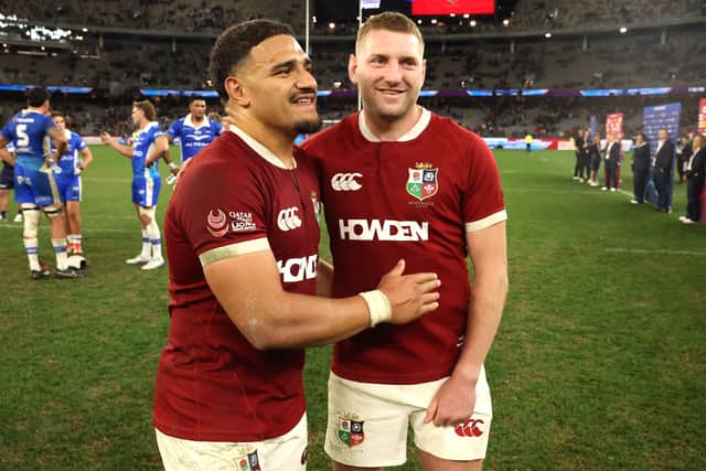 Finn Russell (R) and Sione Tuipulotu of the British & Irish Lions celebrate after their victory during the tour match against the Western Force at the Optus Stadium in Perth.