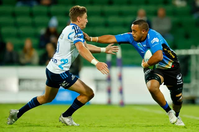 Alex Masibaka shows his power playing for Western Force as he fends off tackler Beauden Barrett of the Blues during a Super Rugby Pacific match in 2022.
