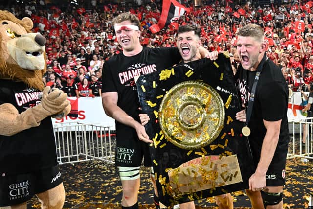 Blair Kinghorn, centre, celebrates with Toulouse team-mates Thibaud Flament, left, and Jack Willis and the Bouclier de Brennus trophy after winning the French Top 14  final against Bordeaux-Begles at the Stade de France.