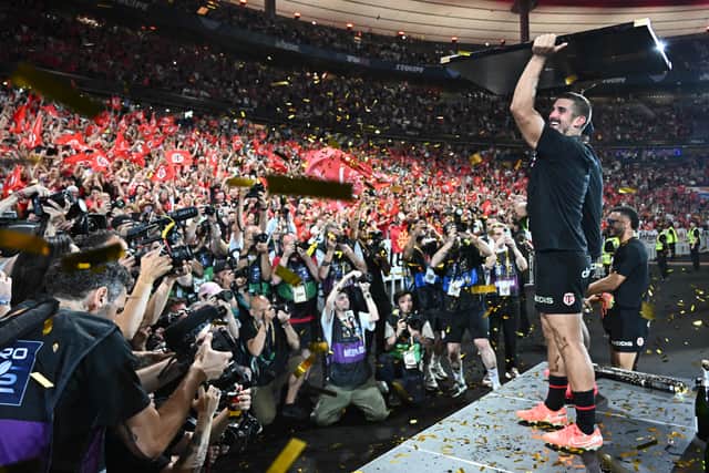 Toulouse's French full-back Thomas Ramos celebrates with the Bouclier de Brennus trophy after the Top 14 final.