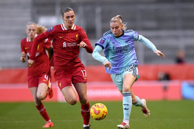 Alessia Russo of Arsenal runs with the ball whilst under pressure from Jenna Clark of Liverpool during the Barclays Women's Super League match between Liverpool and Arsenal last year.
