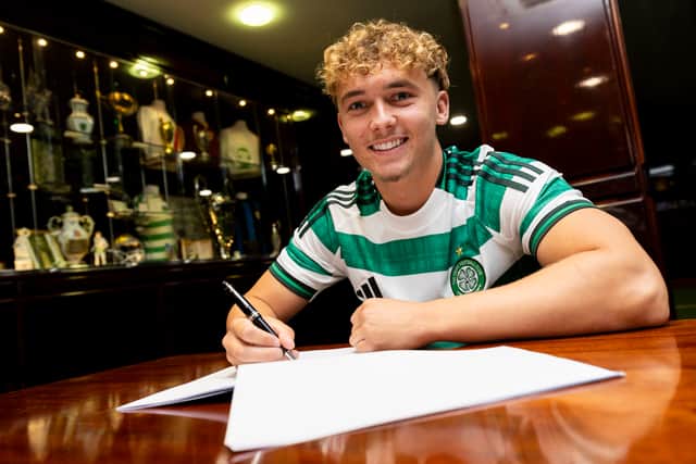 Callum Osmand pens his four-year deal at Celtic.
