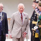 Lord Provost of Edinburgh Robert Aldridge (centre left) and his husband with King Charles III (centre) as he arrived to take part in the Ceremony of the Keys at the Palace of Holyroodhouse.
